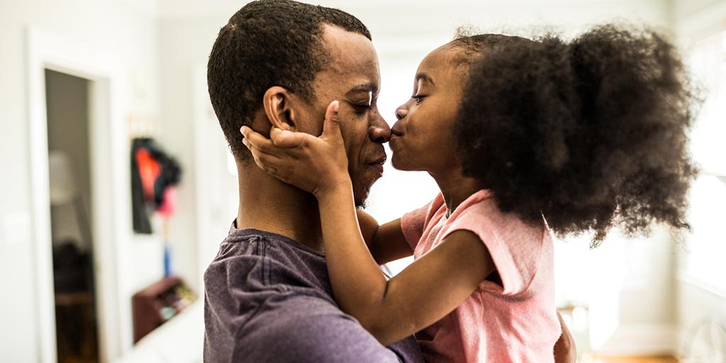 a father hugs his daughter