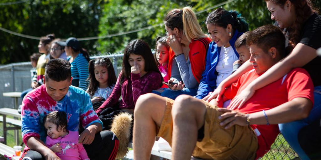 a group of people watch a soccer game