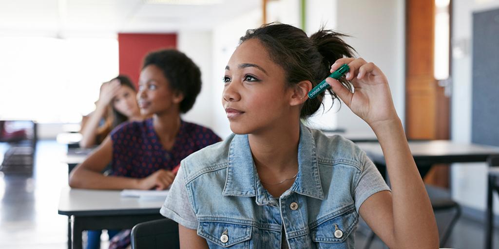 a girl listens in class