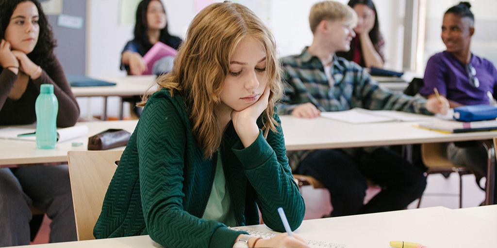 a student takes notes in class