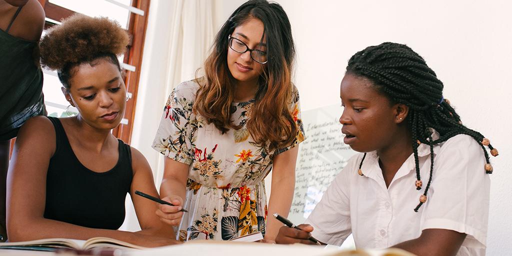 three young women work together