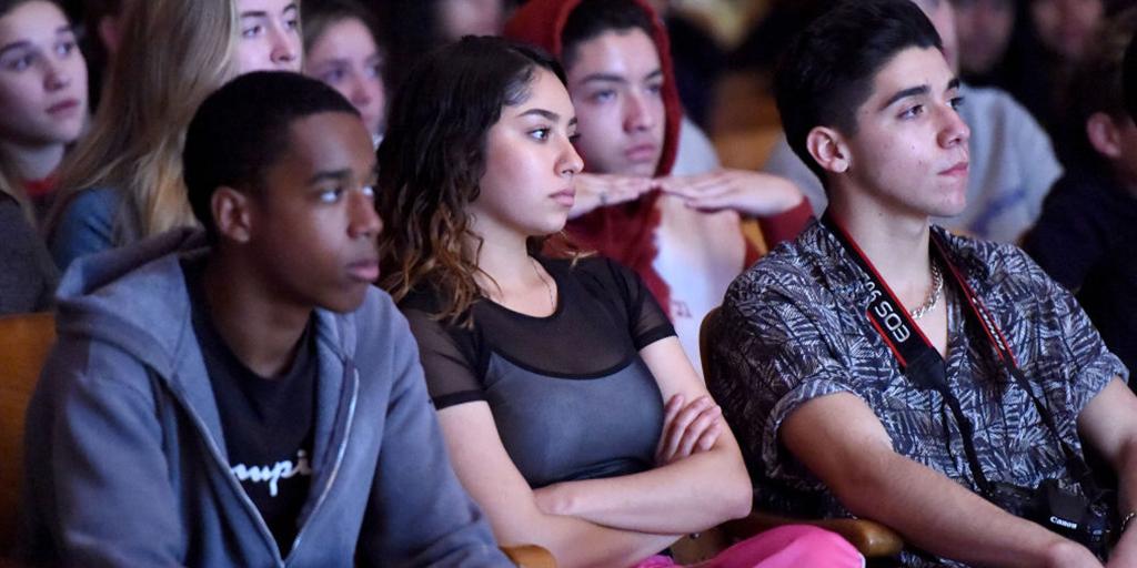 students listen to a discussion on mental health