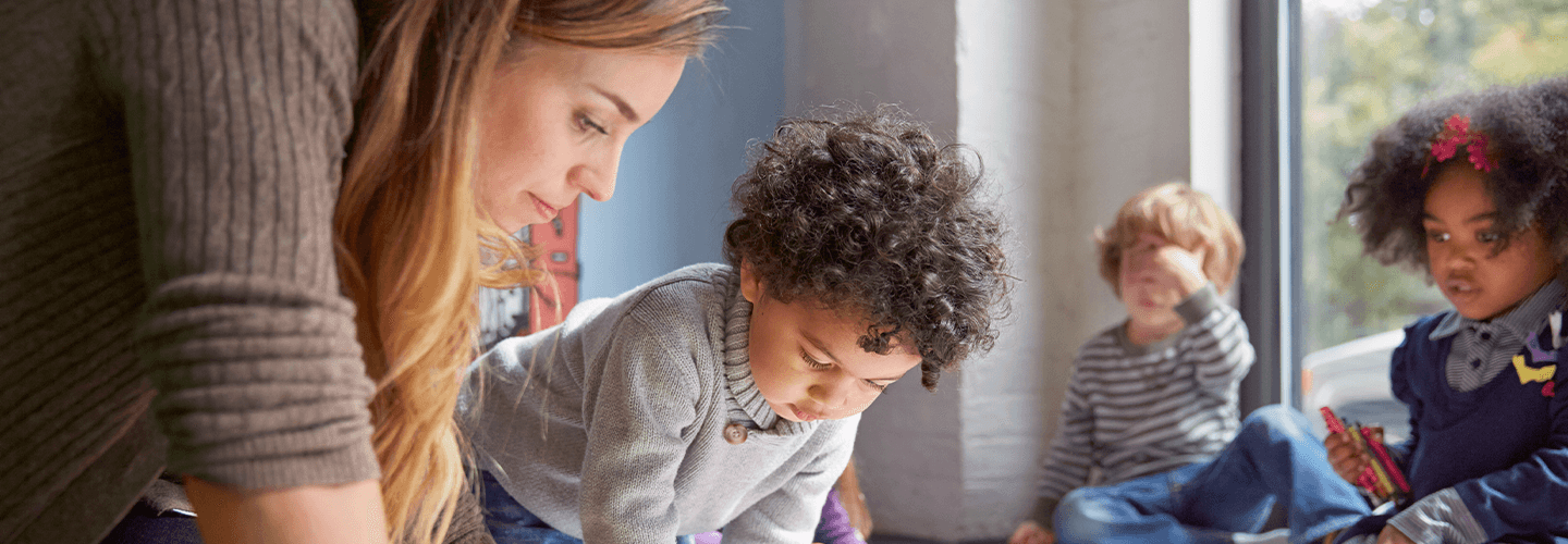 woman with children in daycare setting