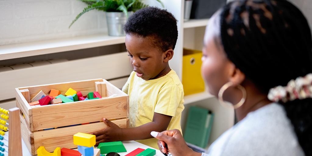 a young boy plays with blocks