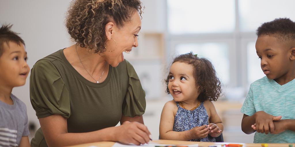 a preschool teacher talks to her students