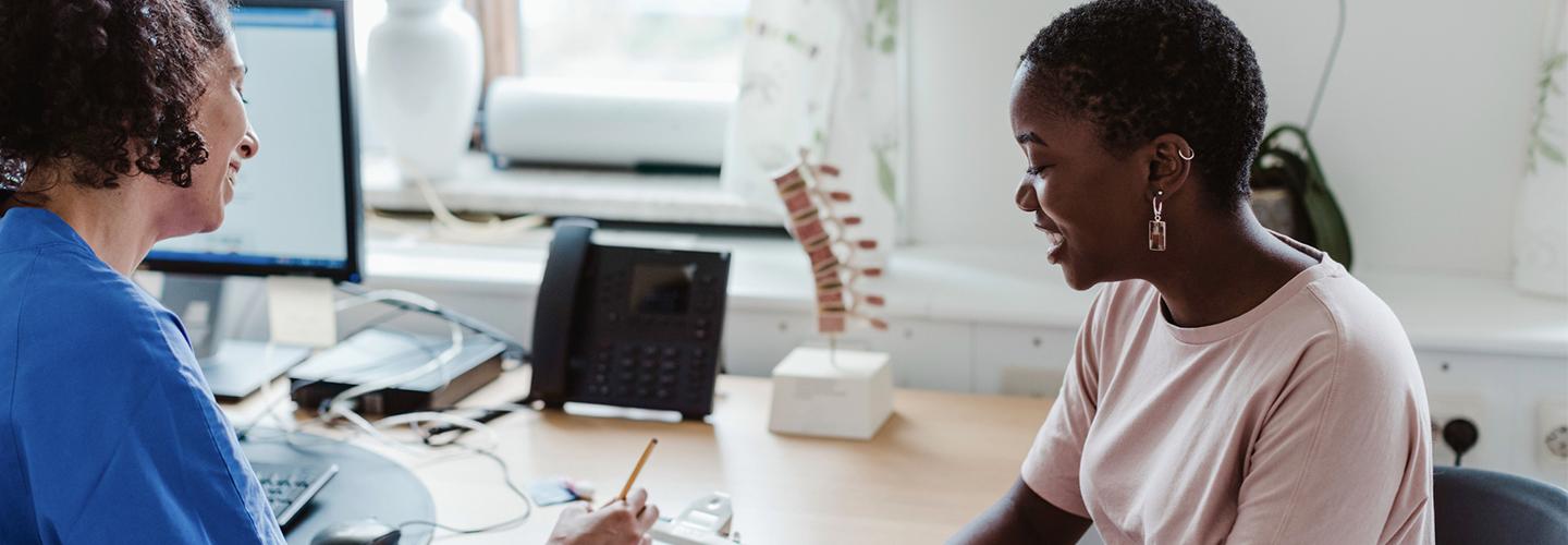 a young woman talks to her nurse